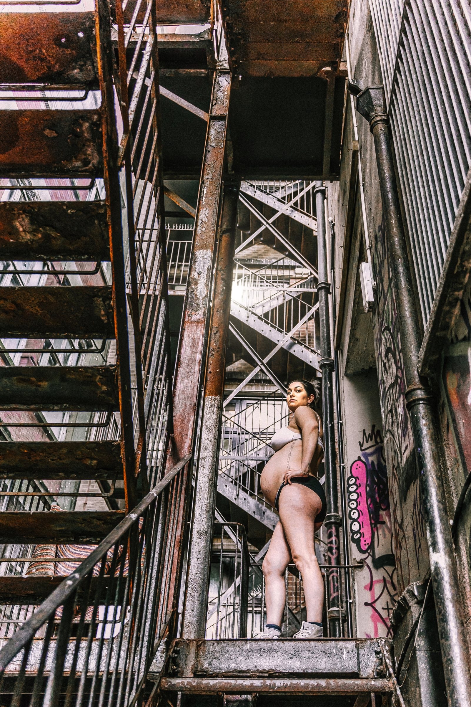 Solene resting against a pier column in soft seaside light