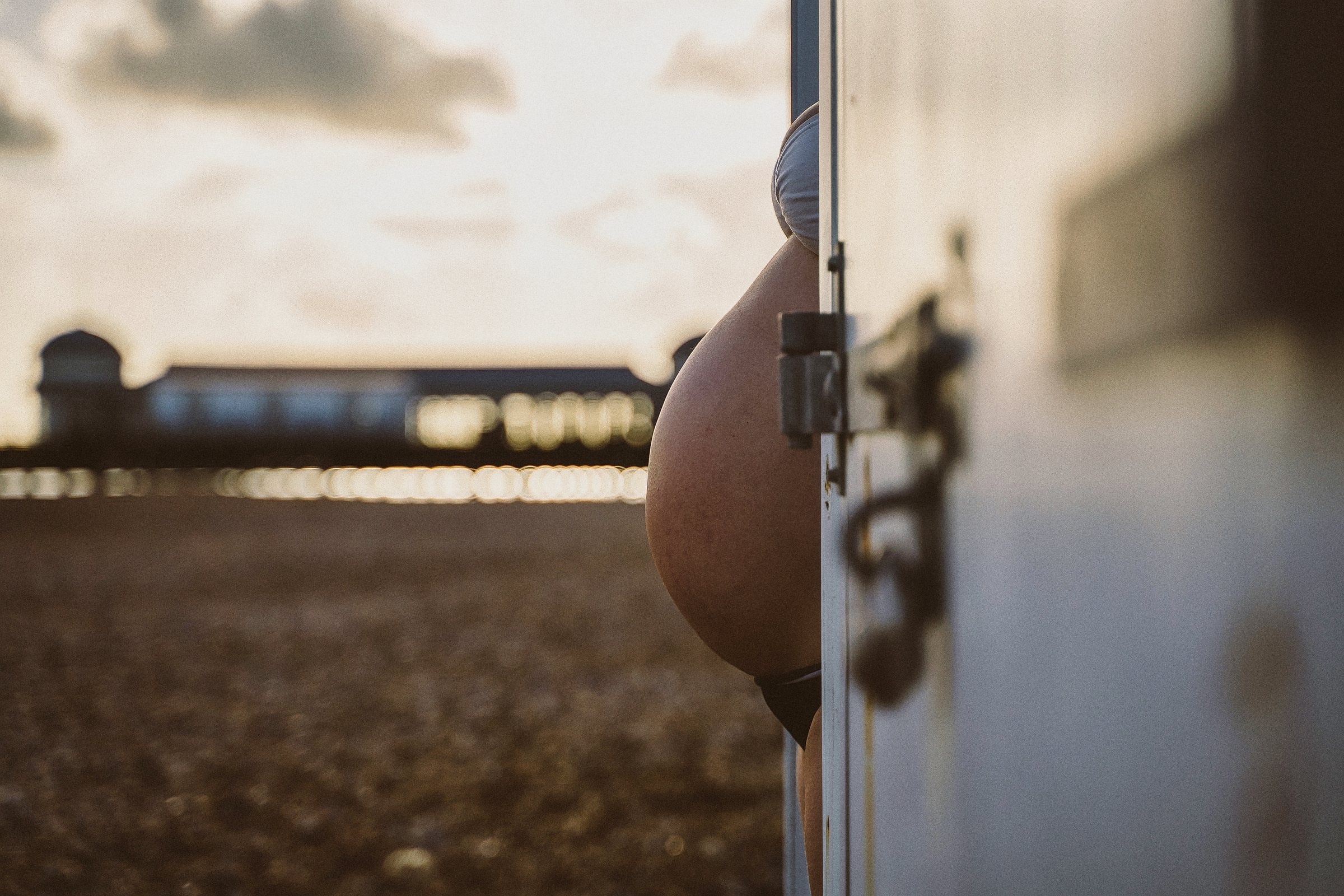 A close study of Solene’s pregnant belly beside the sea