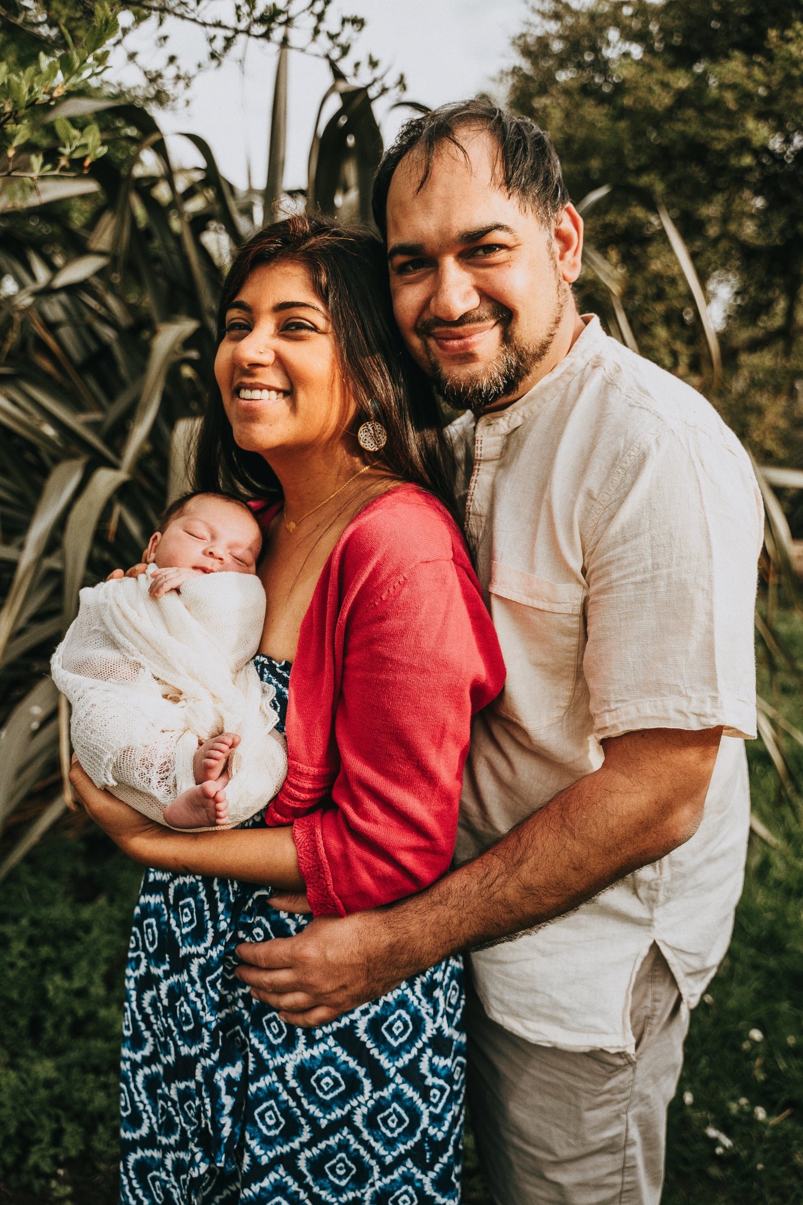 Amaya held close between her smiling parents