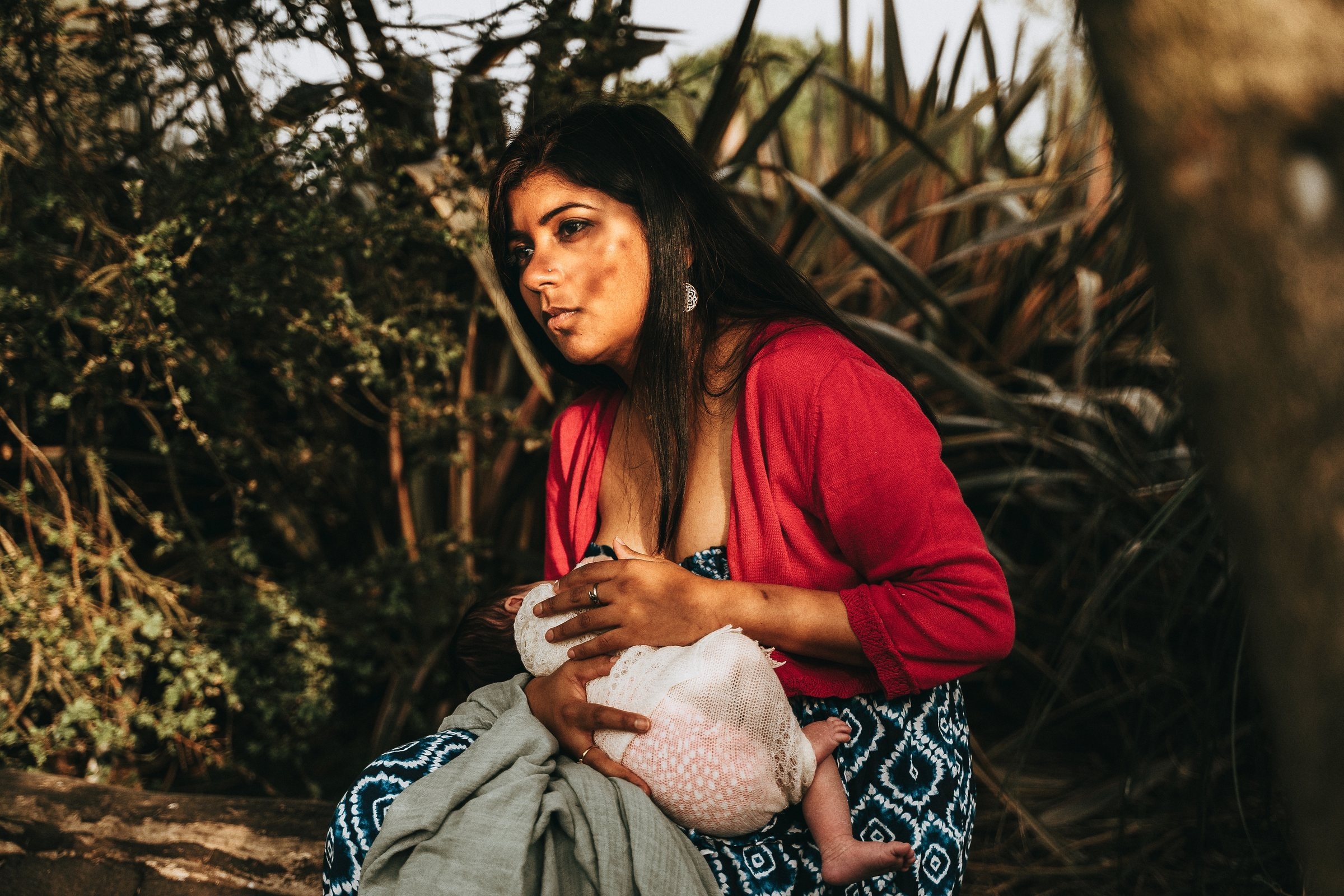 Amaya breastfeeding outdoors in her mother’s arms