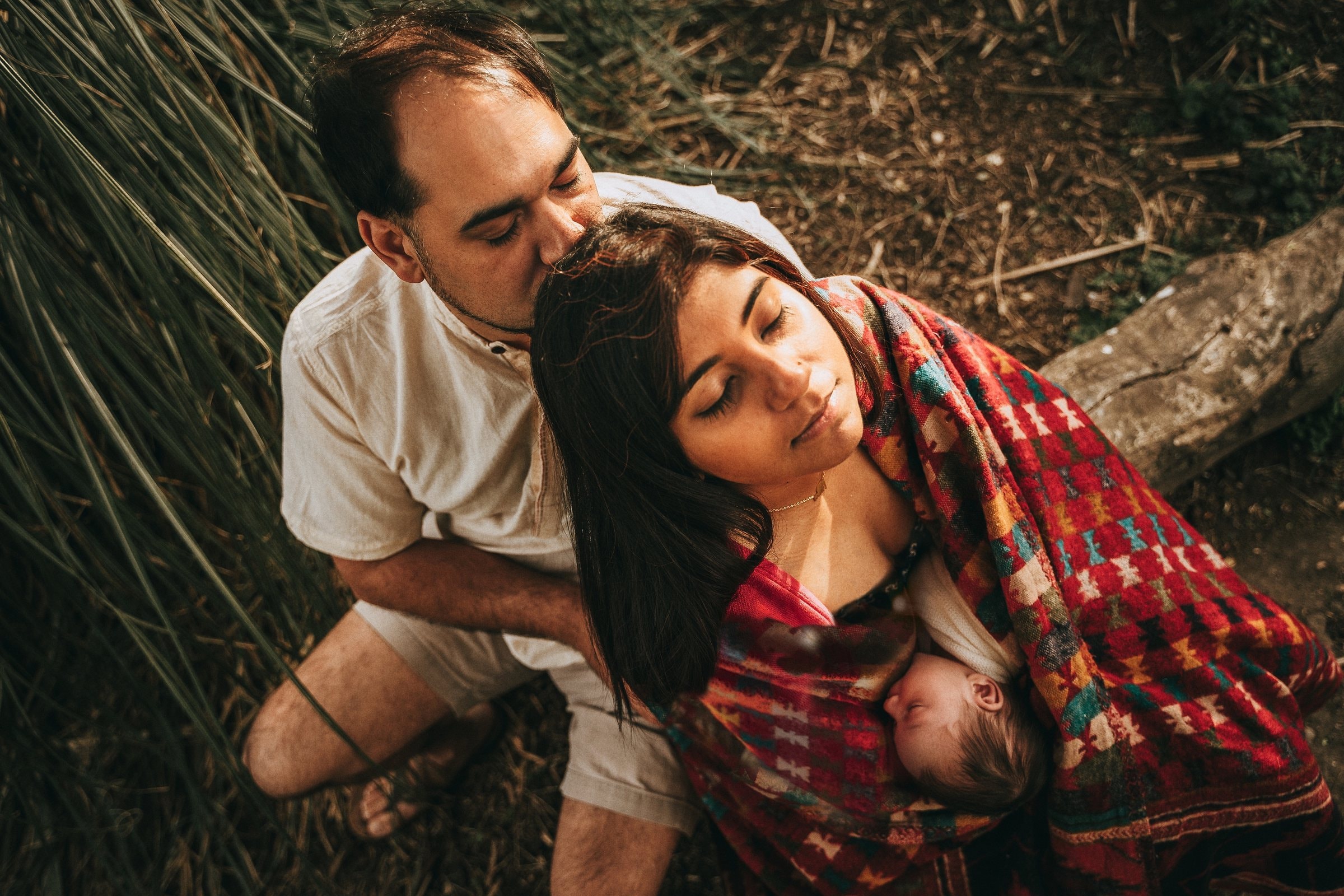 Amaya nursing while her parents hold each other