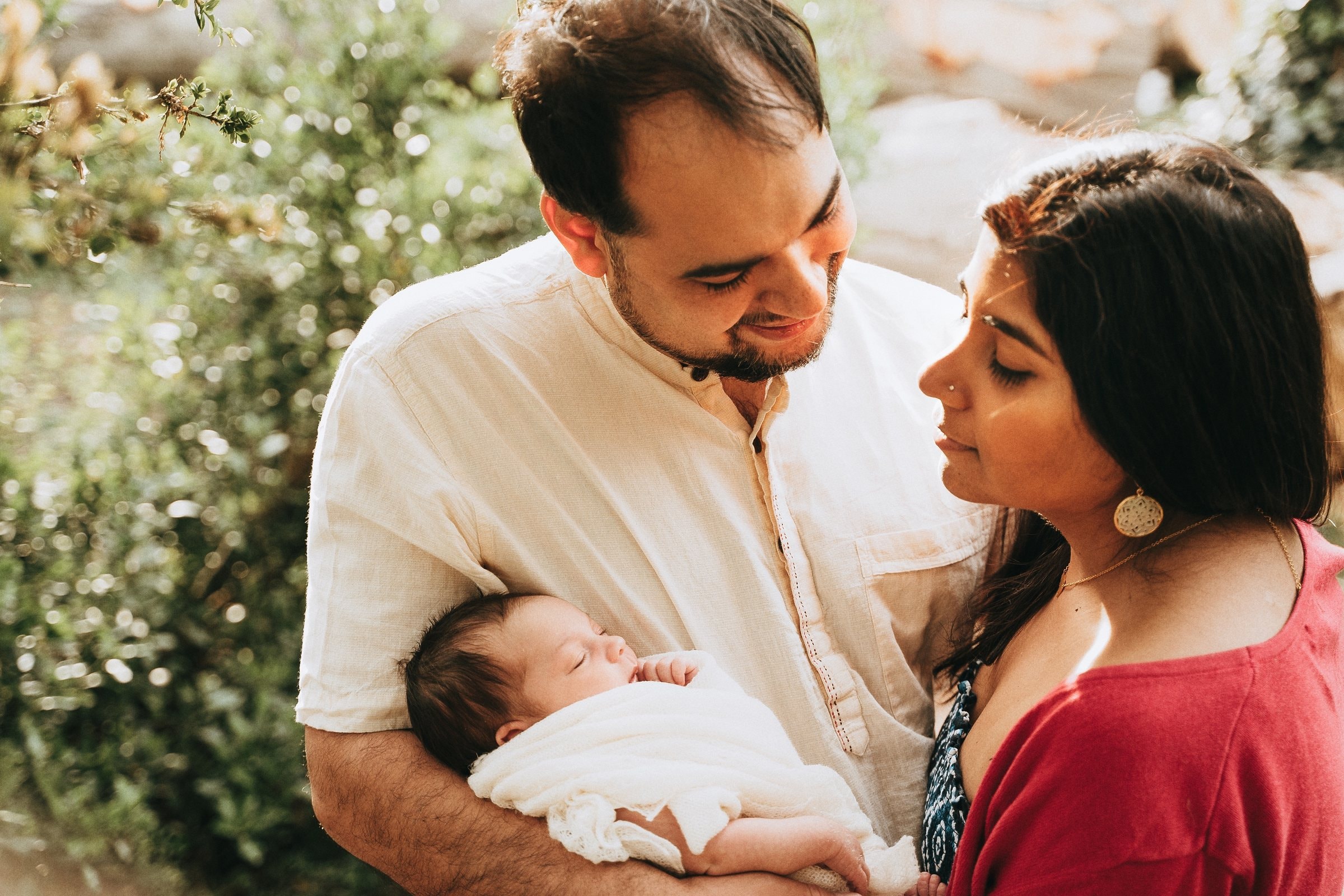 Amaya resting in her parents’ arms