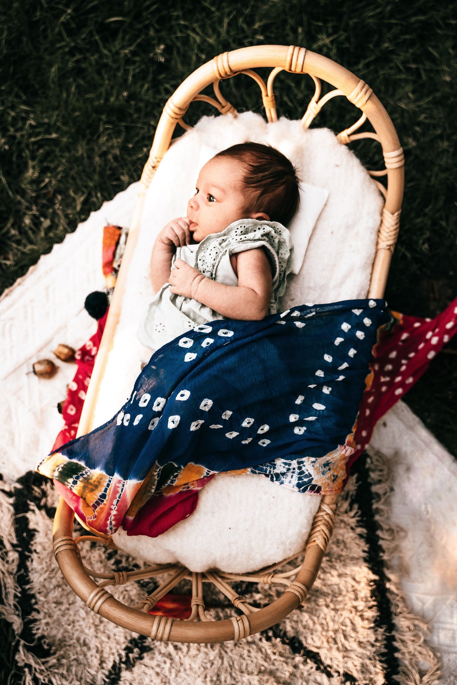 Amaya sleeping in a colourful woven cradle