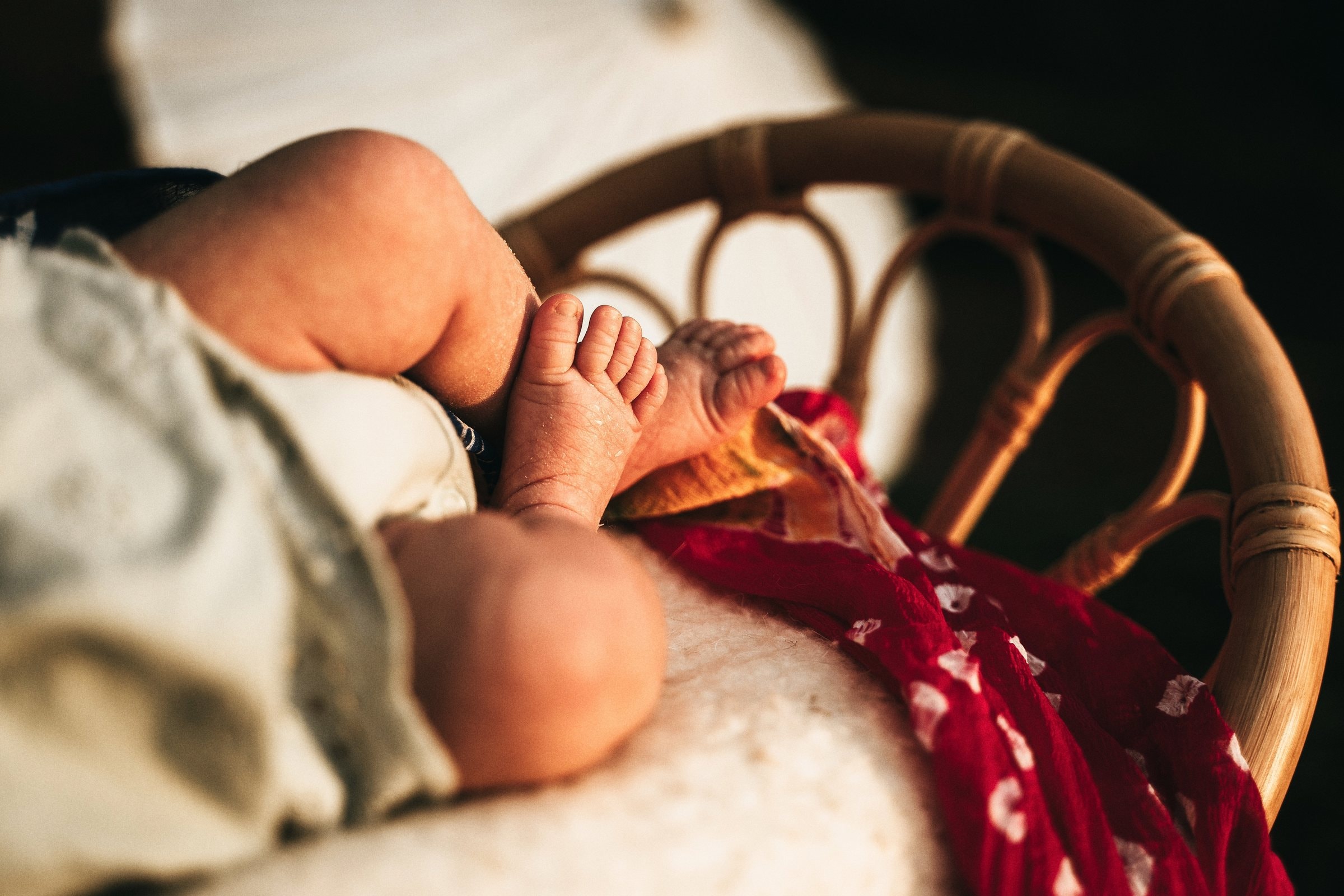 Amaya’s tiny legs resting in warm windowed light
