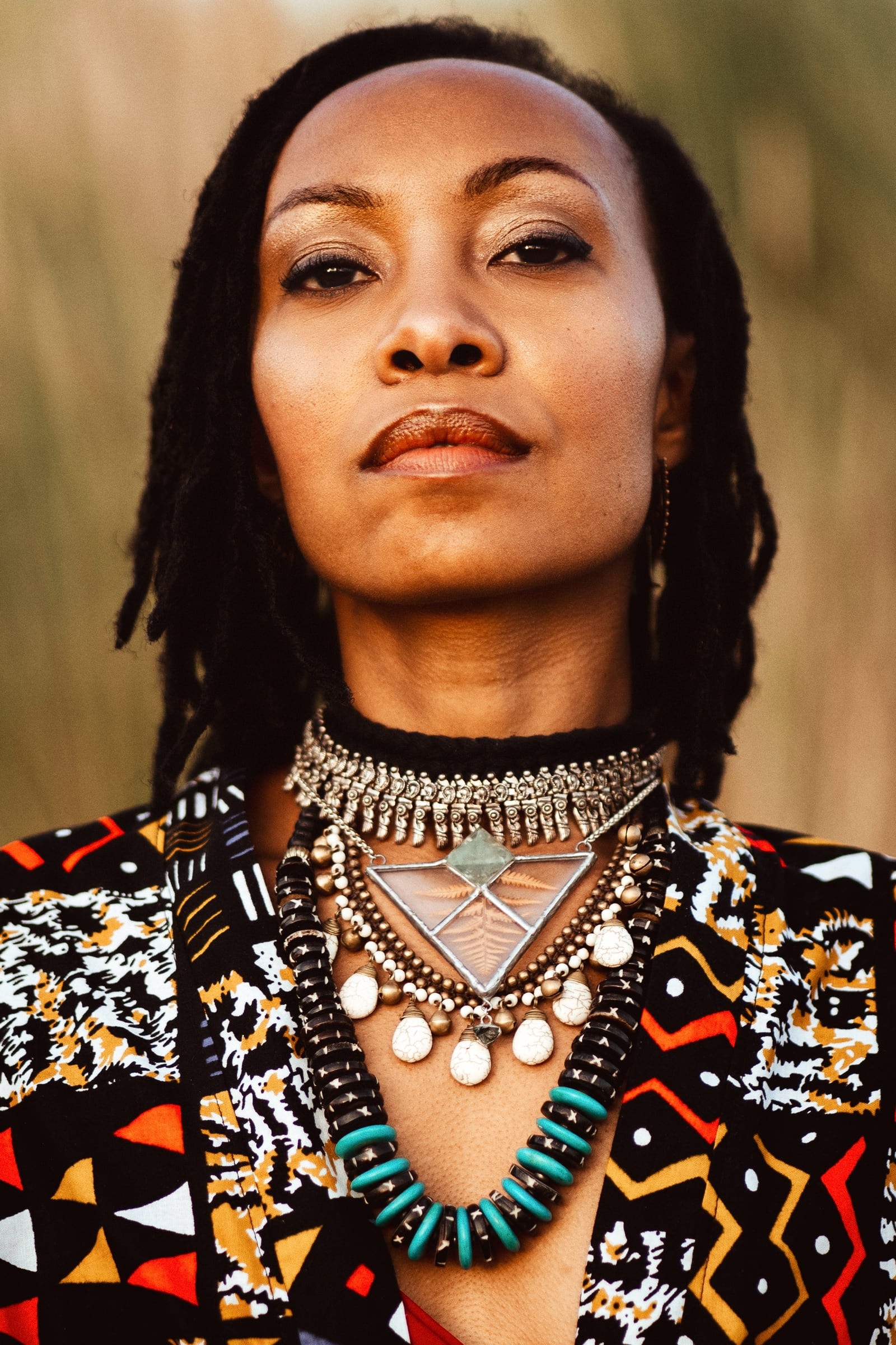 Portrait of a woman wearing layered silver jewellery