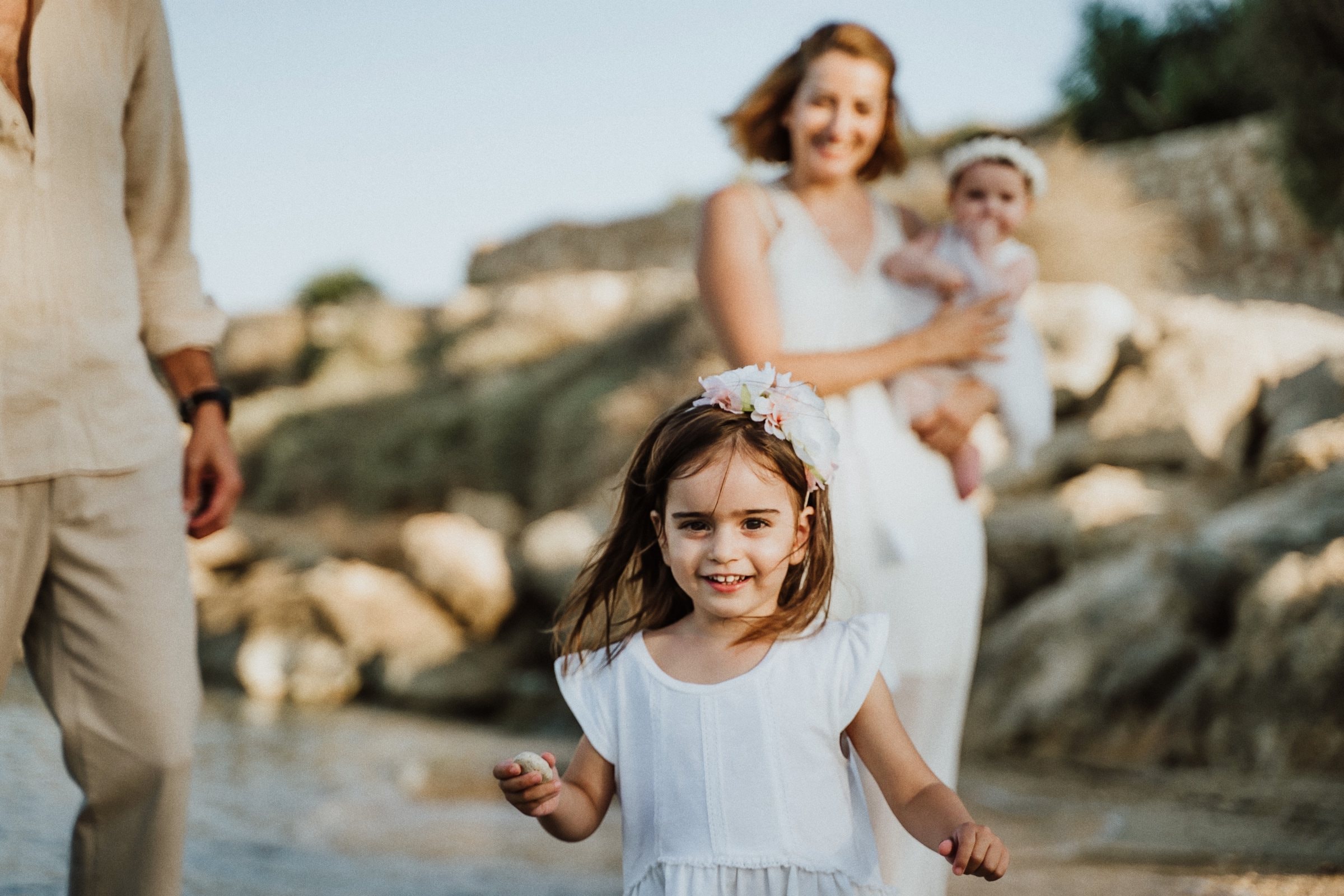 A little girl standing on the rocky Cyprus beach