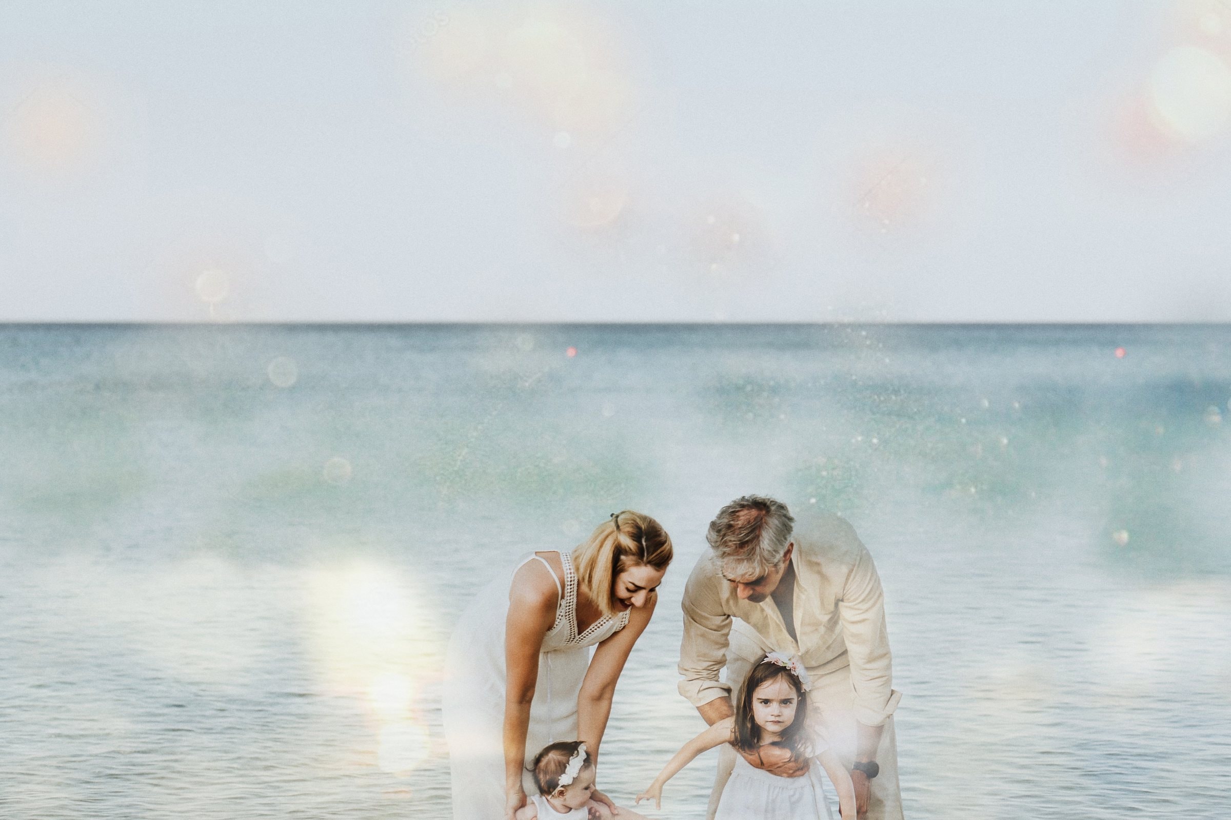 Tasha and her family gathered at the edge of the sea in Cyprus