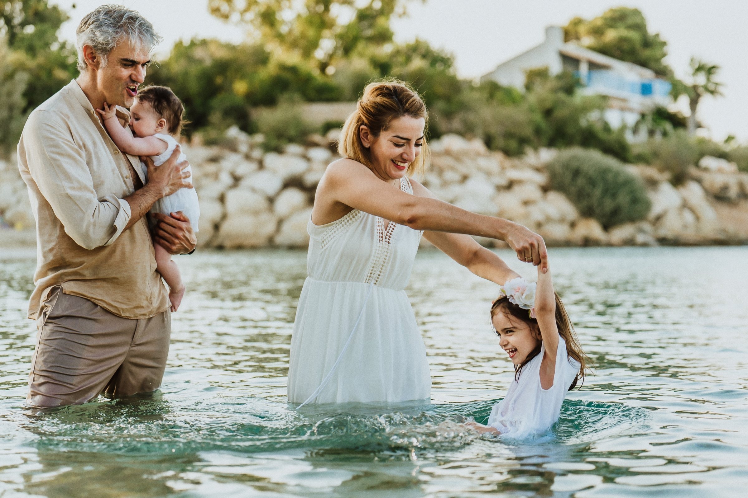 The family playing together in waist-deep water