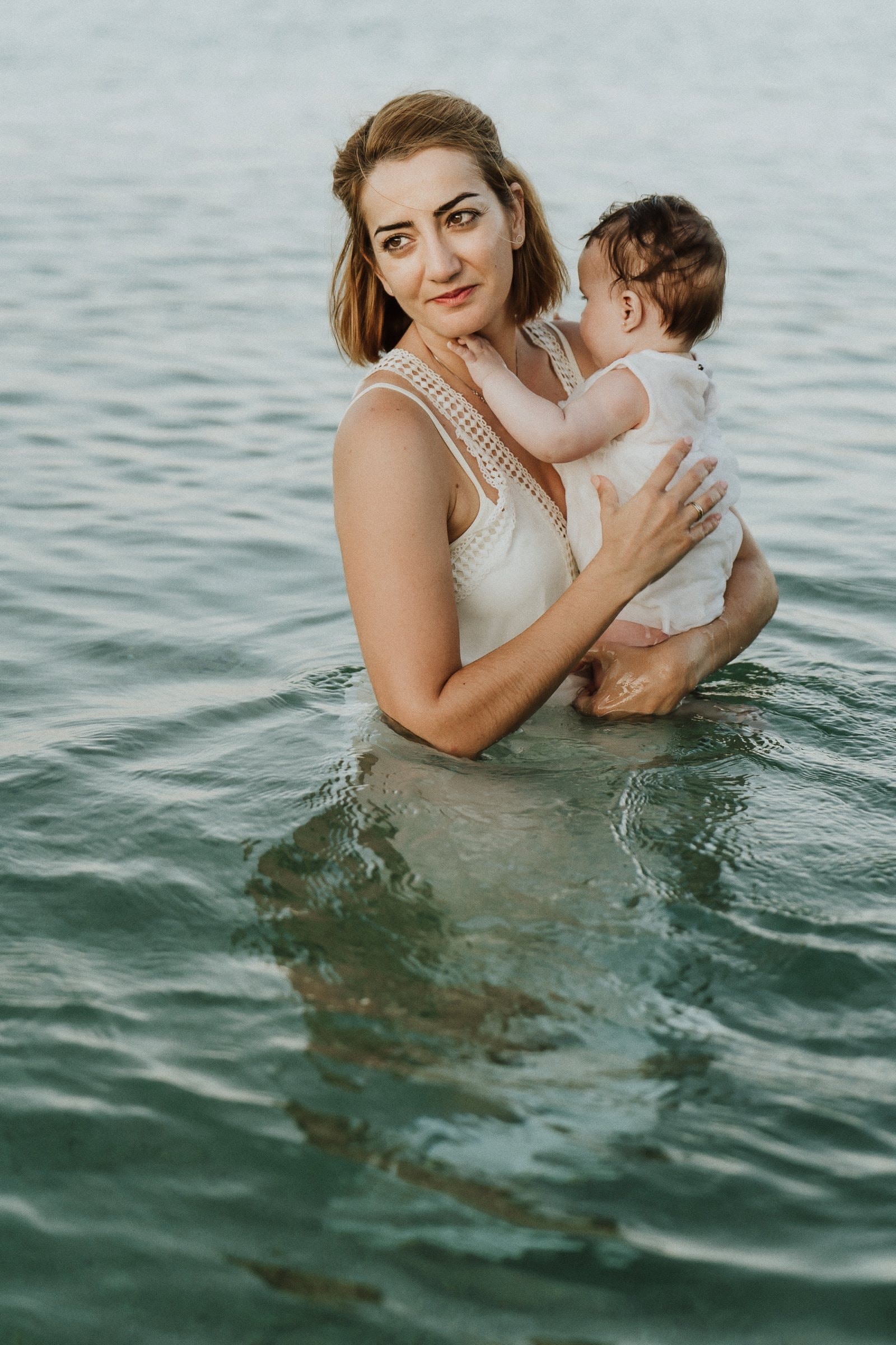 Tasha and her partner laughing with their children on the beach