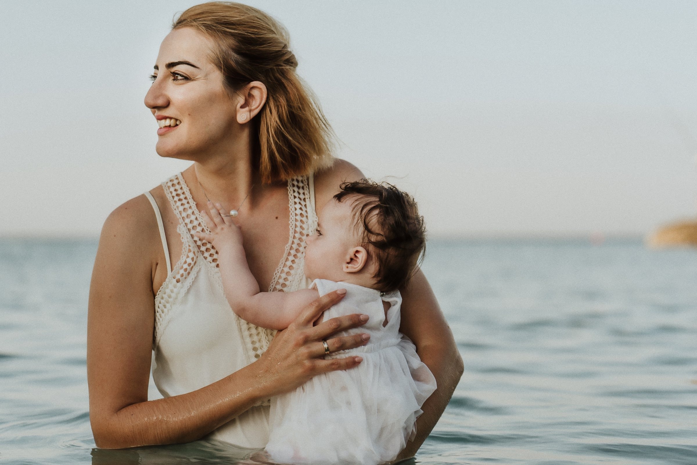 Tasha holding her baby close in the sea