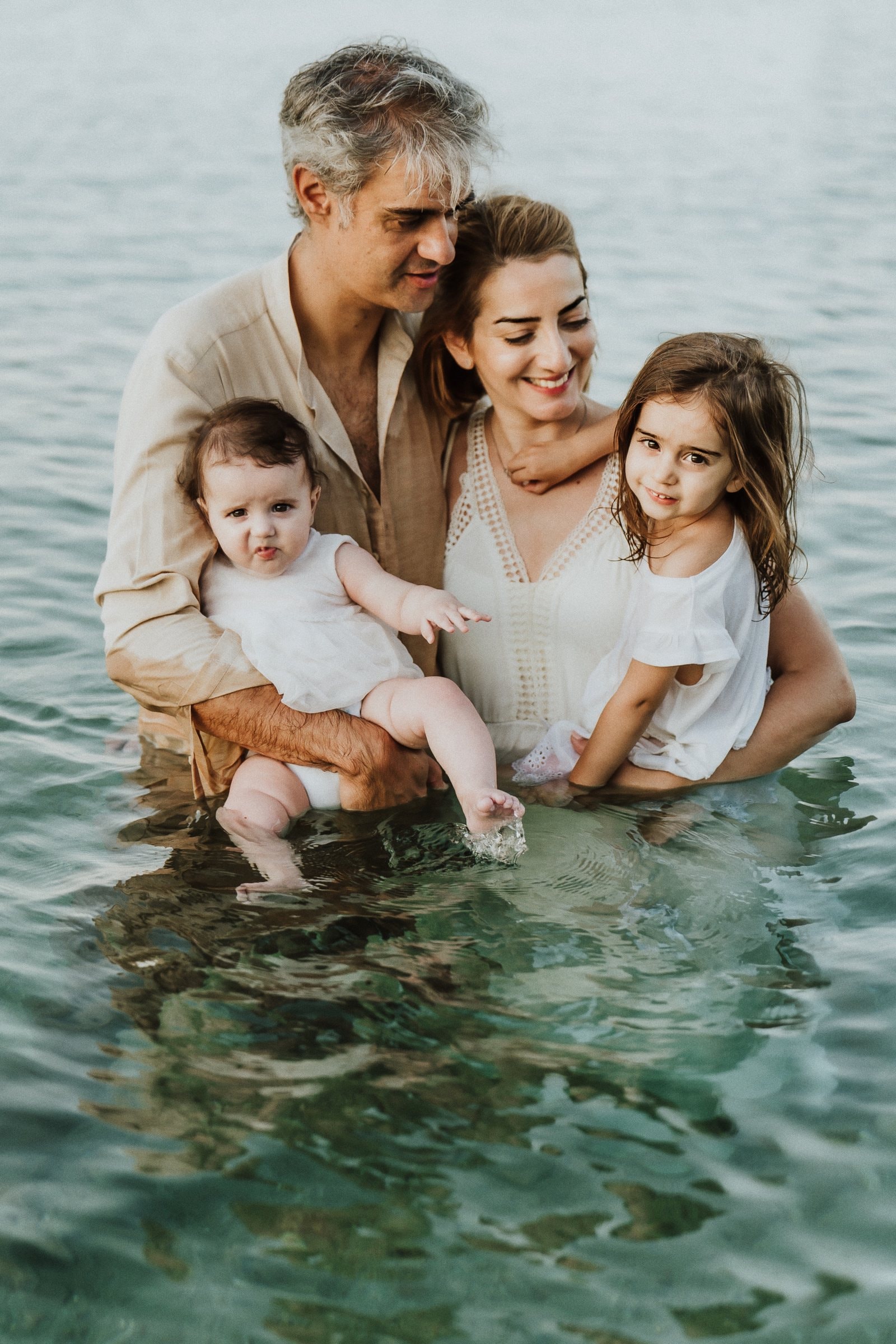 Tasha and her family embracing in waist-deep water
