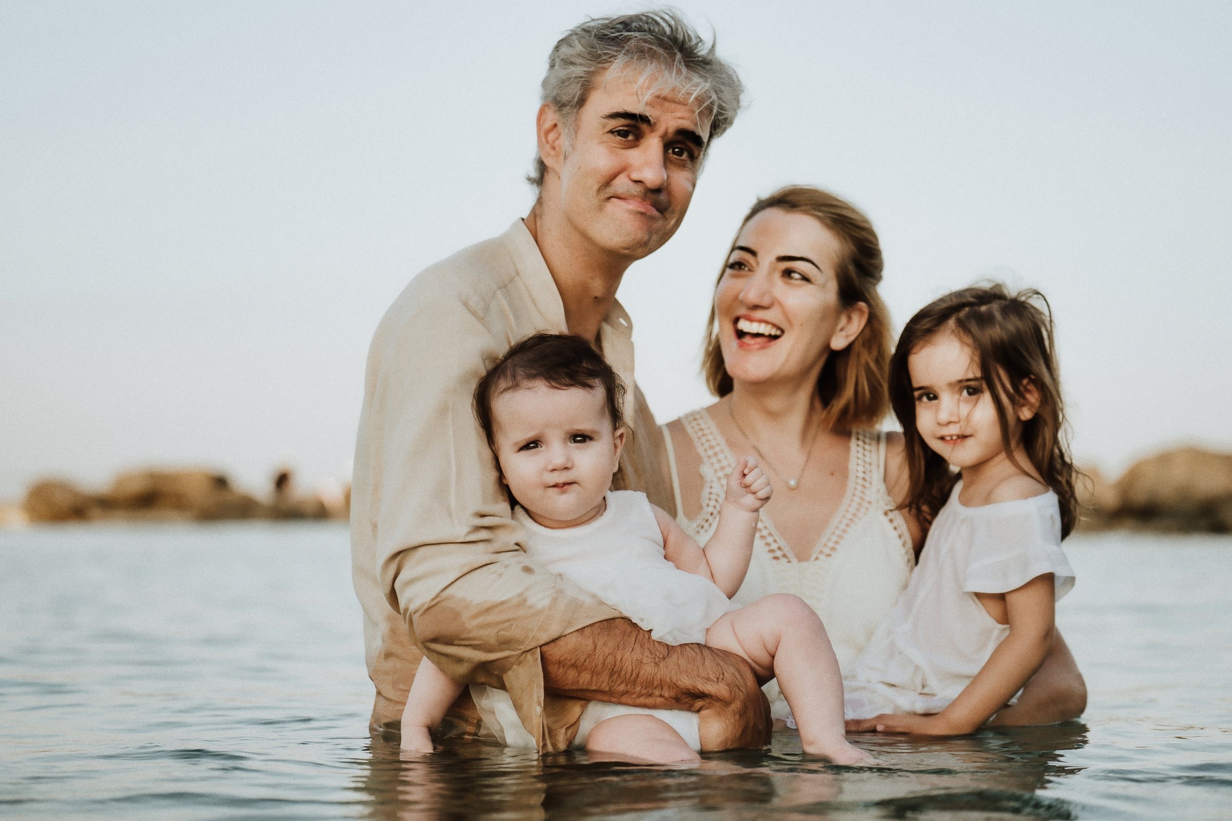 The family gathered close in the sea at sunset