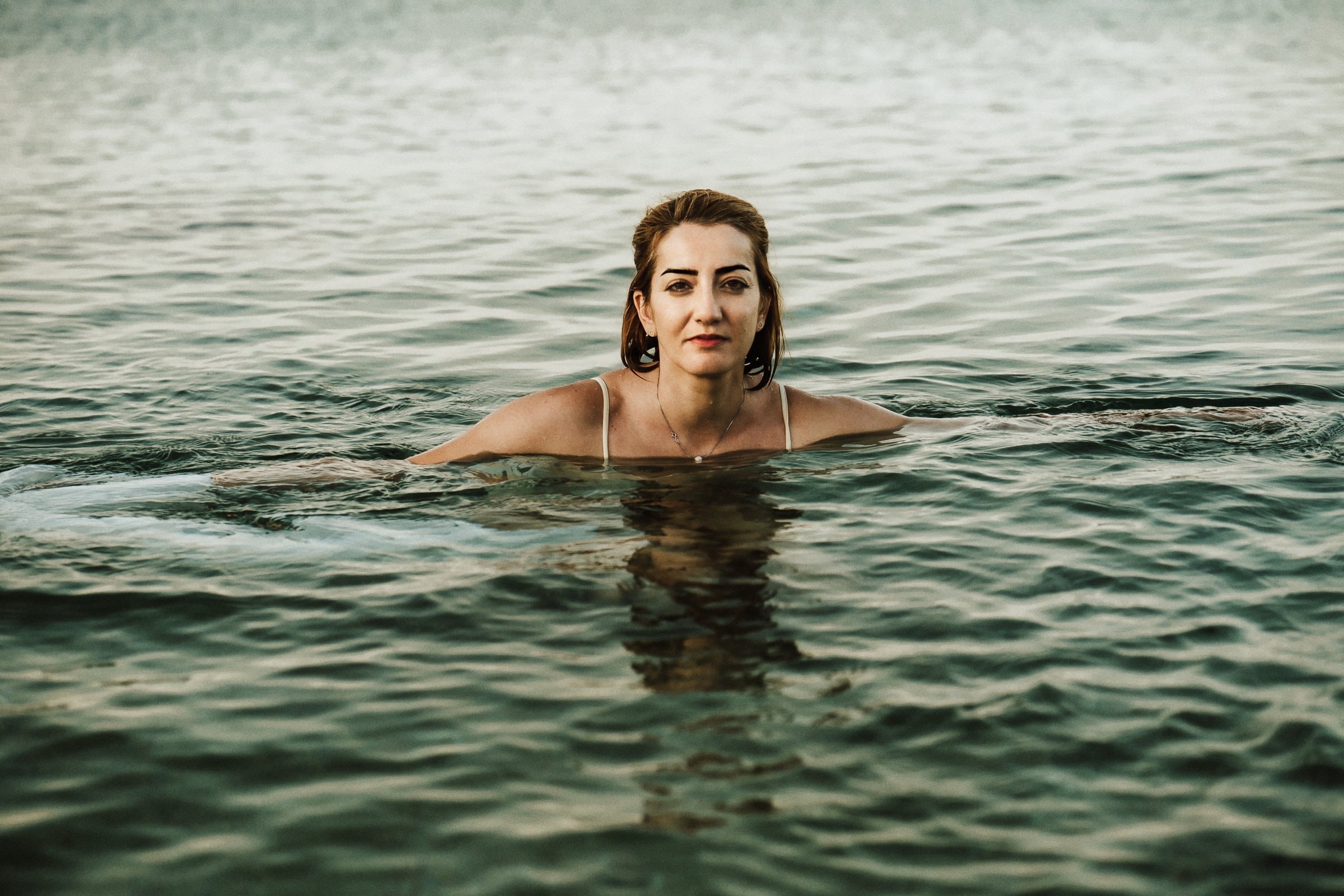 Tasha floating alone in the clear Mediterranean water
