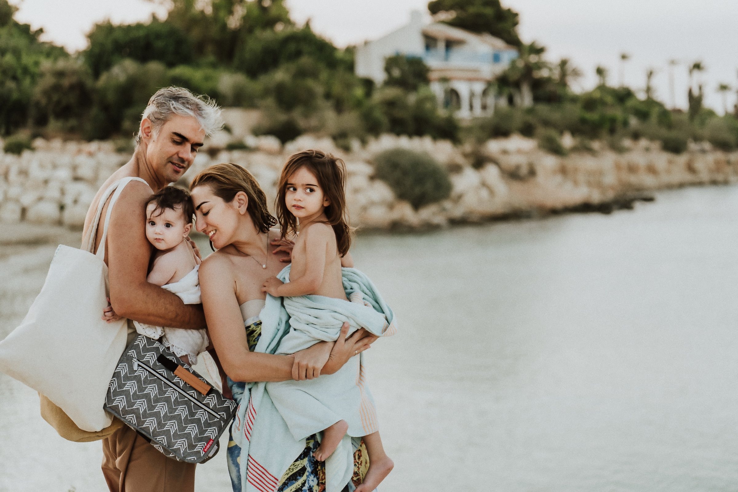 A father holding his children close on the Cyprus coast
