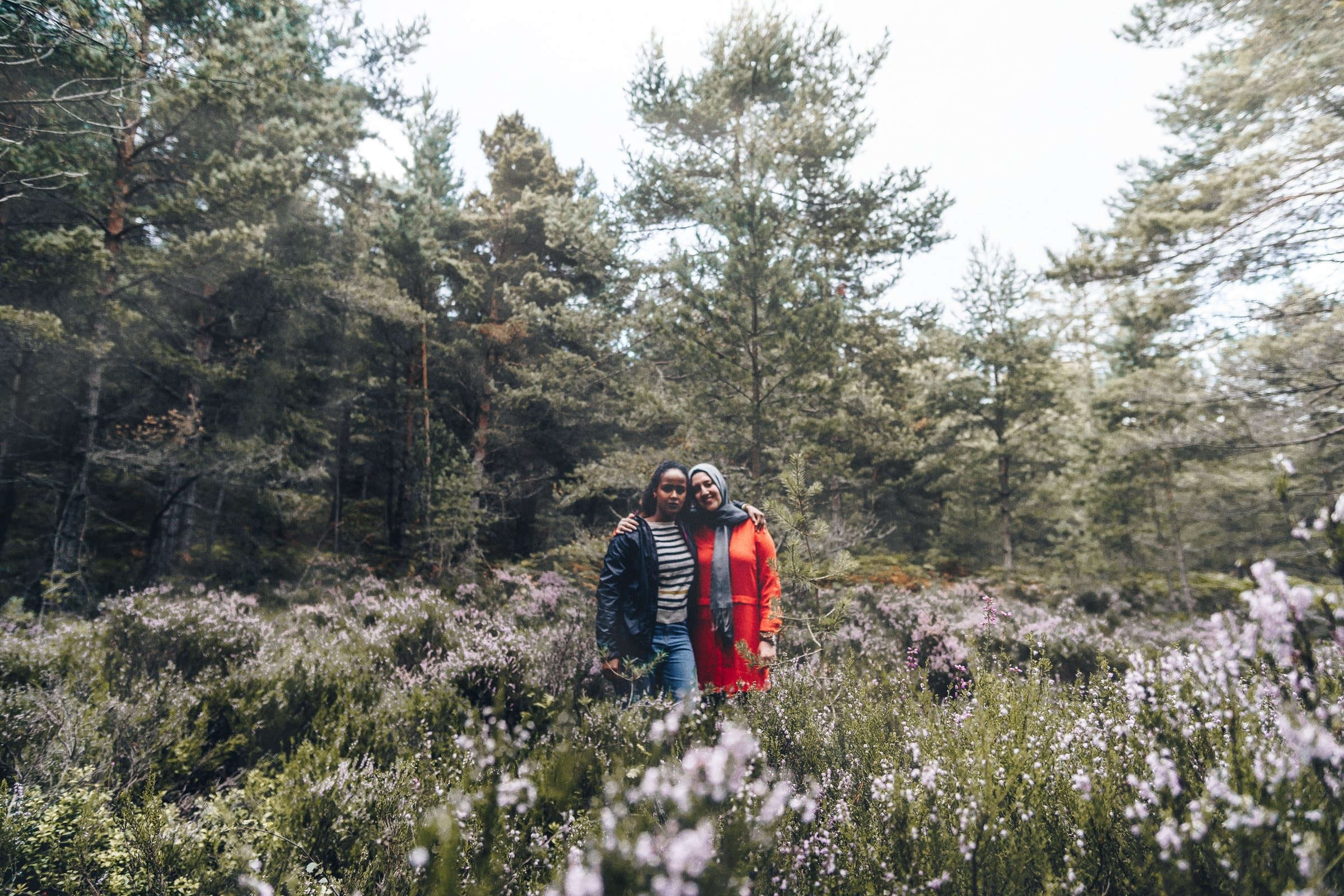 Zainab and her companion standing in a wide Scottish landscape